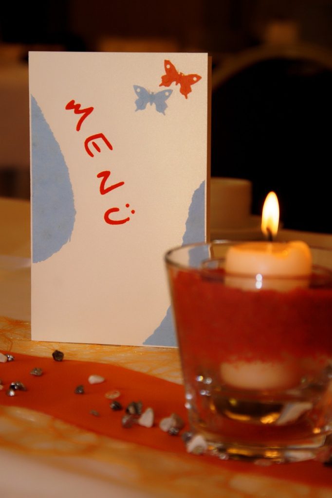 Handwritten menu card & candle.